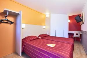 - une chambre avec un lit doté d'un couvre-lit rouge rayé dans l'établissement Premiere Classe Cambrai Proville, à Cambrai