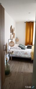 a bedroom with a bed with two lamps on it at La suite d'Arches in Charleville-Mézières