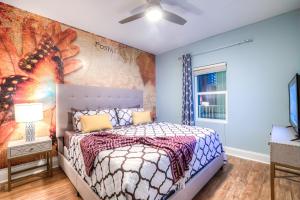 a bedroom with a bed and a wall with a mural at Laketown Wharf Resort 631 By Aneliya in Panama City Beach +87 photos