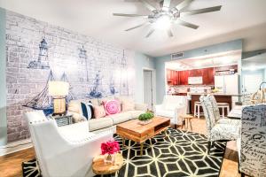 a living room with white furniture and a brick wall at Laketown Wharf Resort 631 By Aneliya in Panama City Beach