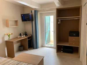 a living room with a door open to a patio at MaLù BEST Rooms - Tropea in Tropea