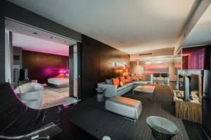 a living room with a couch and a bedroom at StripViewSuites Two-Bedroom Conjoined Suite at Palms Place in Las Vegas