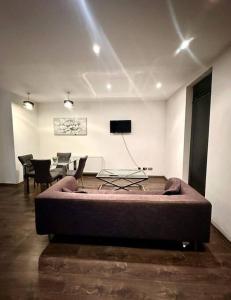 a living room with a bed and a table and chairs at Alarabi Apartments-Peckham in London