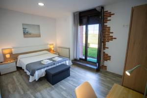 Łóżko lub łóżka w pokoju w obiekcie La casita del abuelo