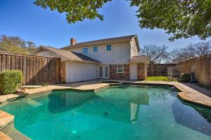 a swimming pool in front of a house at Bright, Airy Home with Pool and Grill! in Richardson