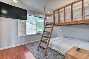 a bunk bed in a room with a ladder towered over a bed at Cliffside Pacifica Hideaway Unbeatable View! in Pacifica