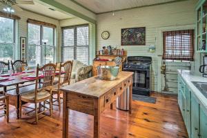 a kitchen with a table and a dining room at Vintage Louisiana Vacation Rental Home in New Roads