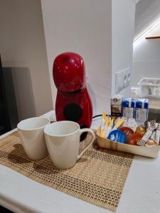 a kitchen counter with two cups and a coffee maker at Acogedor apartamento loft in Alhaurín de la Torre