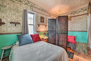 a bedroom with a bed in a room with wallpaper at Historic Houghton Lake Getaway Near Shoreline in Houghton Lake