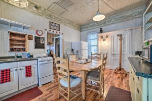 a kitchen with a wooden table and a table and chairs at Historic Houghton Lake Getaway Near Shoreline in Houghton Lake