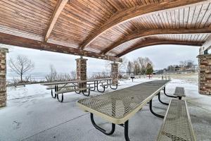 a group of benches sitting under a pavilion at Historic Houghton Lake Getaway Near Shoreline in Houghton Lake