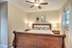 a bedroom with a bed with a ceiling fan at Walk to Coast Galveston Bay Retreat with Grill in San Leon