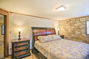 a bedroom with a bed and a stone wall at Scenic Cottage with Views, 17 mi to San Antonio! in San Antonio