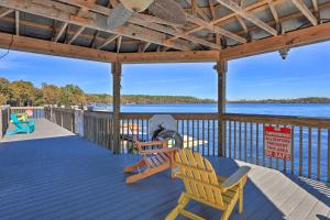 a deck with two chairs and a table and chairs on it at Family Resort Condo with 2 Pools 1 Mi to Disney! in Orlando