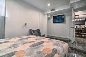 a bedroom with a bed and a tv on a wall at Central El Paso Home with Fire Pit! in El Paso