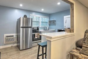 a large kitchen with a stainless steel refrigerator at Atlanta Area Studio with Creek Access! in Lawrenceville