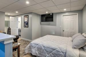 a bedroom with a bed and a flat screen tv at Atlanta Area Studio ~ 3 Mi to Gas South Arena! in Lawrenceville