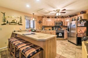 a kitchen with wooden cabinets and stainless steel appliances at Mtn-View Angel Fire Condo, Less Than 1 Mile to Resort! in Angel Fire