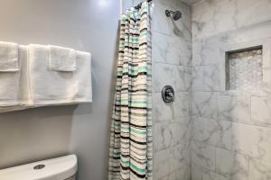 a bathroom with a shower and a toilet at Atlanta Area Studio ~ 3 Mi to Gas South Arena! in Lawrenceville +16 photos