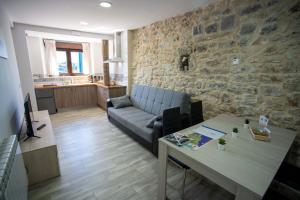 a living room with a couch and a table at La casita del abuelo in Galizano