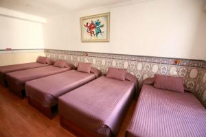 a row of beds with pillows and pillows on them at Residencial Joao XXI in Lisbon