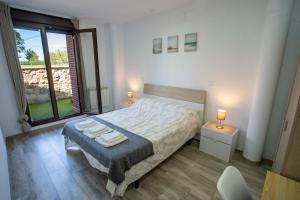 Łóżko lub łóżka w pokoju w obiekcie La casita del abuelo