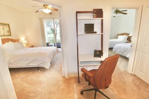 a bedroom with a bed and a chair and a mirror at Treasure Coast Getaway in Carlton