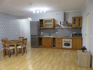 cocina con mesa y nevera de acero inoxidable en Apartment Raatuse 82, Tartu kesklinnast 700m kaugusel, en Tartu
