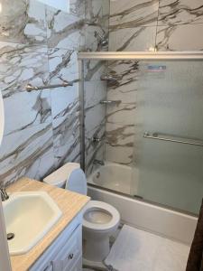 a bathroom with a sink and a toilet and a shower at The Best Vacation Home To Fit All Your Needs! in Hyattsville