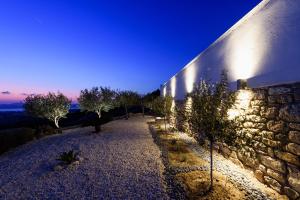 a stone building with lights on the side of it at Villa Sunset in Aliki