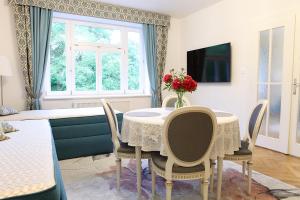 a dining room with a table and chairs and a window at Apartmá v srdci Poděbrad in Poděbrady