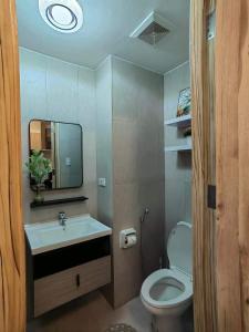 a bathroom with a sink and a toilet and a mirror at Triann Condo Staycation Davao in Inspiria Condominium Building in Davao City