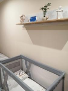 a staircase with a shelf and a laptop on it at Apartamenti Miera Osta in Liepāja