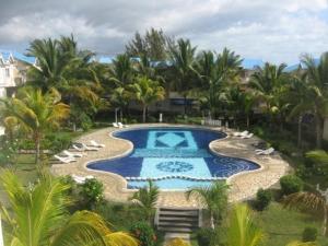 an overhead view of a swimming pool with chairs and trees at Le Dattier -dreambeach in Flic-en-Flac +29 photos