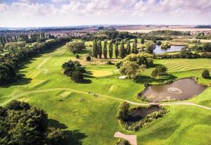 an overhead view of a golf course with two ponds at Coppergate Mews Grimsby No.5 - 1 bed, 1 bath, 1st floor apartment in Grimsby
