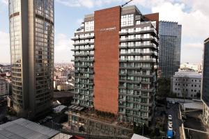 a tall red brick building in a city at The Mill Bomonti in Istanbul
