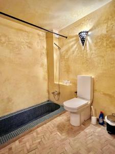 a bathroom with a toilet and a shower at Riad Dar Hanae in Tétouan