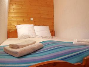 a bed with two towels on top of it at Appartement Valmorel, 3 pièces, 6 personnes - FR-1-291-765 in Valmorel