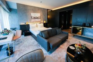 a hotel room with a couch and a bed at The Mill Bomonti in Istanbul