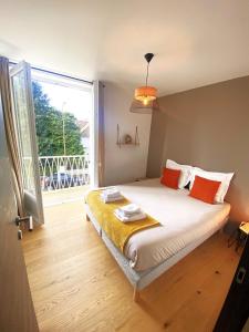 a bedroom with a bed and a large window at WHITE HOUSE DHAVERNAS - PROCHE CENTRE - PARKING - WIFi HD in Amiens