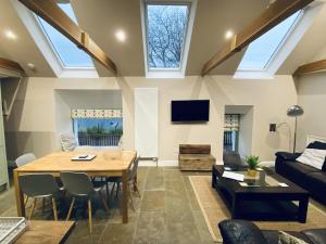 a living room with a table and a couch at Earnbank in Lochearnhead