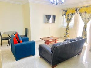 a living room with two couches and a table at APEX ANNEX Guest Facility in Buea