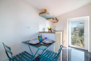 a small kitchen with a table and chairs in a room at Torre antica Case di Campo in Cisano sul Neva