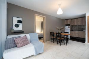 a living room with a white couch and a table at Camping Stolos in Limín Litochórou +34 photos