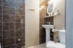 a bathroom with a toilet and a sink at Camping Stolos in Limín Litochórou