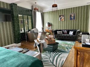 a living room with green wallpaper and a couch at Atholl Arms Hotel in Dunkeld
