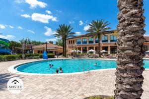 a pool at a resort with people in it at 2 Bedrooms 2,5 Bathrooms Regal Oaks 2604 Rl in Orlando