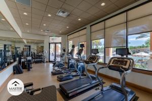 a gym with several treadmills and elliptical machines at 2 Bedrooms 2,5 Bathrooms Regal Oaks 2604 Rl in Orlando