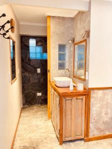 a bathroom with a sink and a mirror at La Maison Gerber in Río Colorado