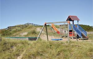 an empty playground in a grassy field at One-Bedroom Apartment In Ringkobing in Ringkøbing +24 photos